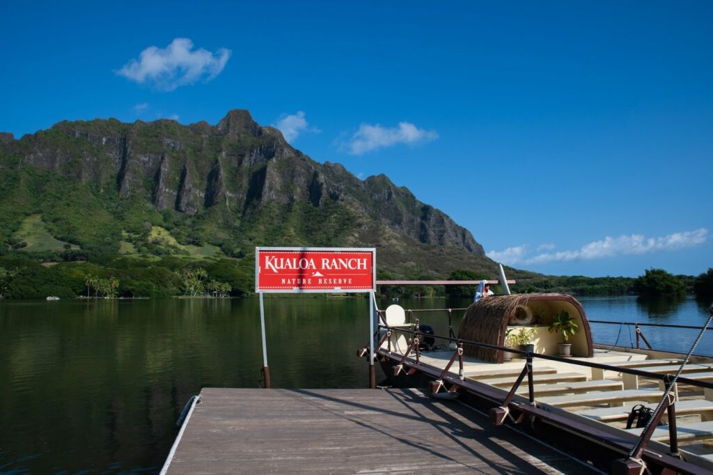 Things to do in Oahu with kids at Kualoa Ranch, showing a dock, and mountain views. 