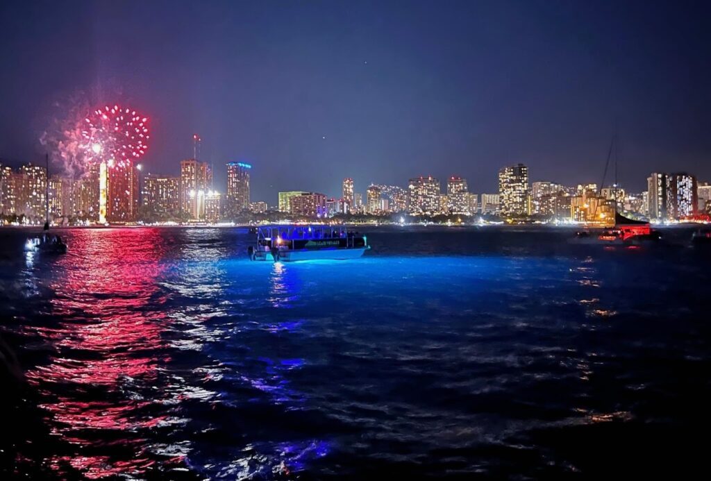 City skyline fireworks over asunset cruise boat displaying sunset photography tips.