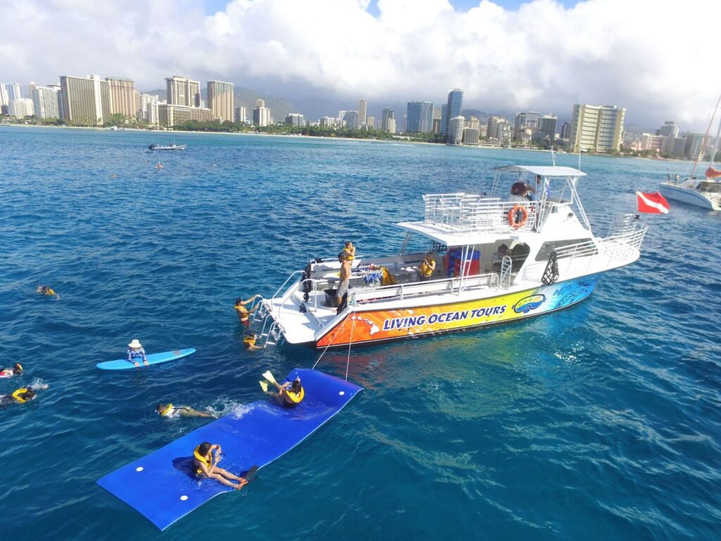 Tourists snorkeling near Waikiki, a must-do activity in Oahu daily itinerary.