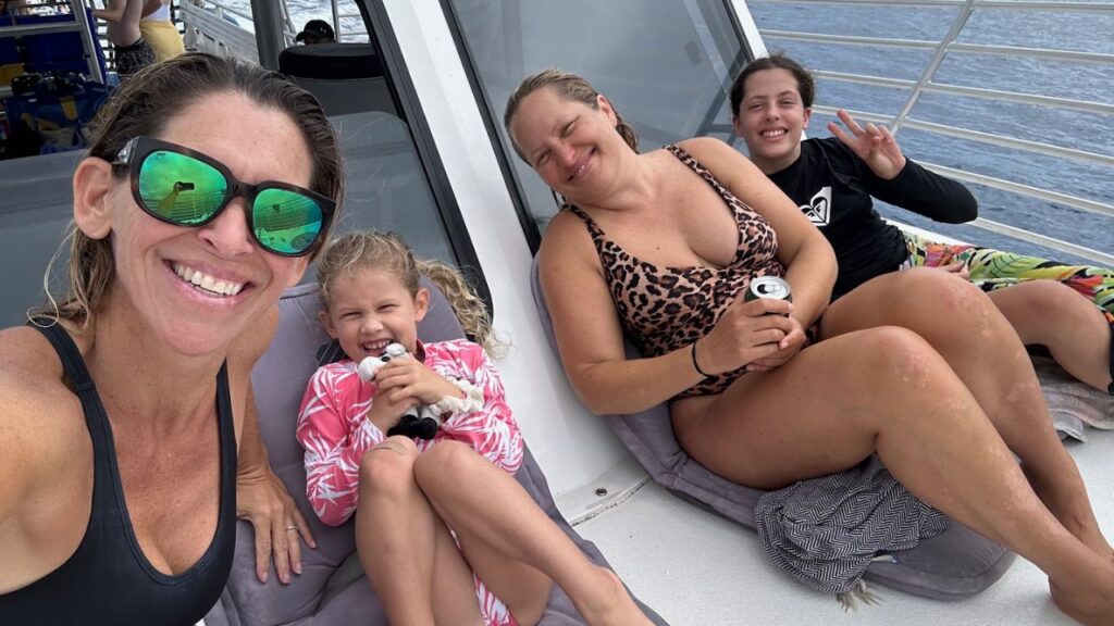 Guests posing with a kid on a cruise in Honolulu.