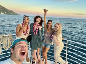 Booze cruise in Oahu, Waikiki, with ocean views, drinks, and sunset over the Pacific.