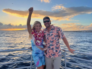 Couple enjoying sunset from a sunset cruise in Waikiki.