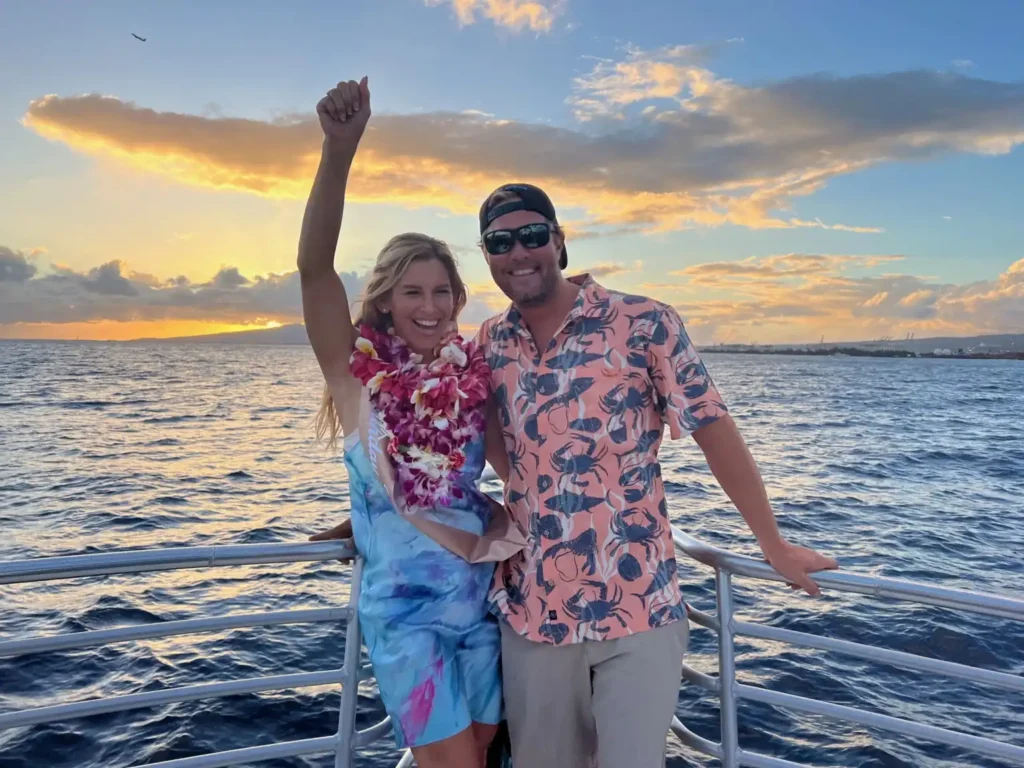 Couple enjoying sunset from a sunset cruise in Waikiki.