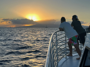 Sunset boat trip in Honolulu with a scenic Waikiki skyline and golden sunset over the ocean